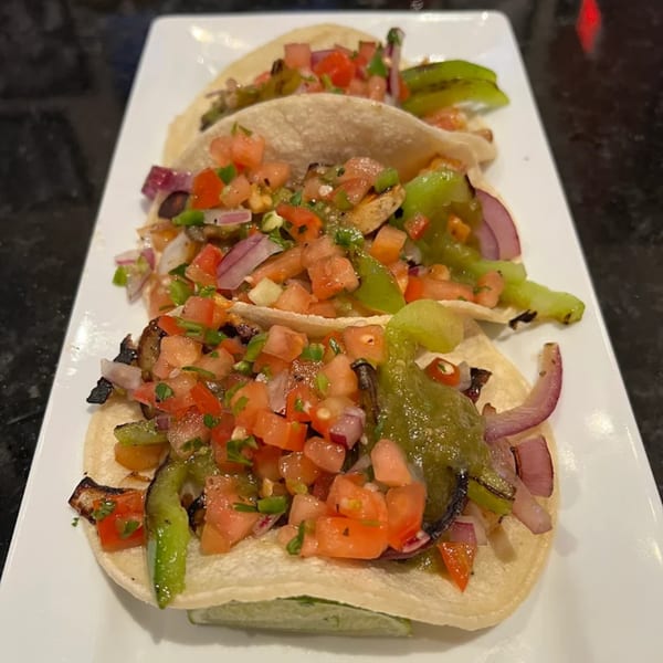 Three Jams@209 Sports Bar & Grill tacos with grilled peppers, onions, and pico de gallo.