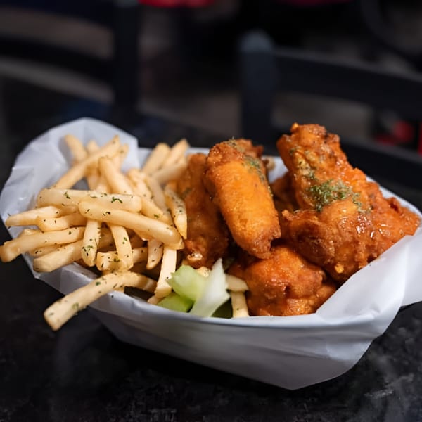 A basket of Jams@209 Sports Bar & Grill's crispy chicken wings and seasoned french fries.