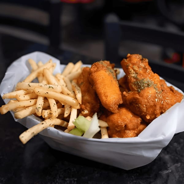 A basket of Jams@209 Sports Bar & Grill's crispy chicken wings and seasoned french fries.