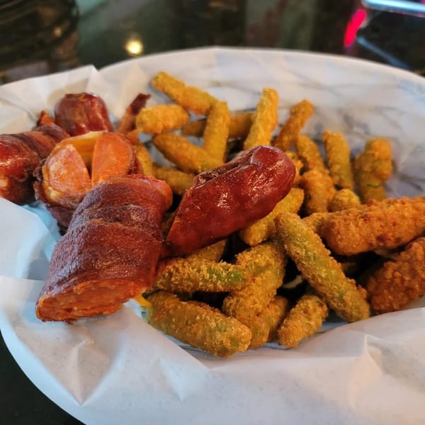 A basket of bacon-wrapped sausages and crispy fried green beans from Jams@209 Sports Bar & Grill.
